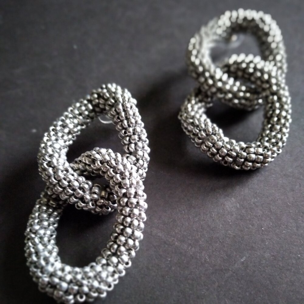 Pierced Double Oval Earrings Puffed Up and Entwined with One Another